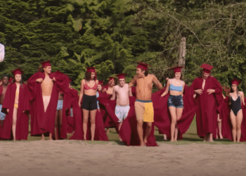 A group of boys throw away their robes at the beach in a scene from the Netflix movie 'Hello, Goodbye, and Everything in Between'