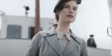Juliet Ashton (Lily James) seeing something while she's on a boat in the Netflix movie 'The Guernsey Literary and Potato Peel Pie Society'.