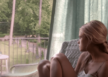 Jade Butterfield (Gabriella Wilde) sitting on a chair looking outside in the 2014 movie 'Endless Love'.