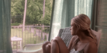 Jade Butterfield (Gabriella Wilde) sitting on a chair looking outside in the 2014 movie 'Endless Love'.