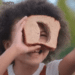 Bean (Madison Skye Validum) playing with a slice of bread in the Netflix movie 'Ivy + Bean: The Ghost That Had to Go'.