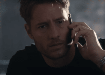 Jake Turner (Justin Hartley) talking to the phone with an astonished expression in the Netflix movie 'The Noel Diary'.