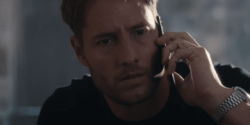 Jake Turner (Justin Hartley) talking to the phone with an astonished expression in the Netflix movie 'The Noel Diary'.