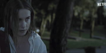 Raqeul (Clara Galle) leaning on a tree in the Netlix movie 'Through My Window'.