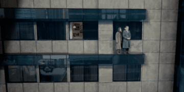 A man contemplates suicide from a building window in the movie 'The Dreamseller'.