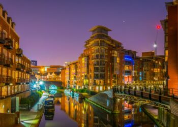 Night view of brick buildings alongside a water channel in the central Birmingham, England