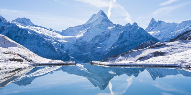 The Alps reflected in the snowy Bachalsee Lake.