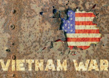 American flag and inscription Vietnam war on rusty armor of a military vehicle