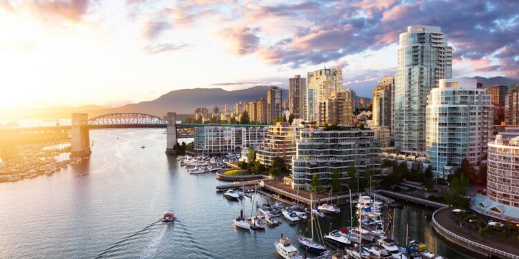 False Creek, Downtown Vancouver, British Columbia, Canada. Beautiful Aerial View of a Modern City on the West Pacific Coast during a colorful Sunset. Sky Composite