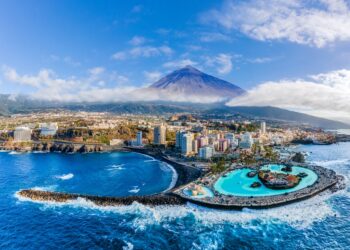 Aerial view with Puerto de la Cruz, in background Teide volcano, Tenerife island, Spain