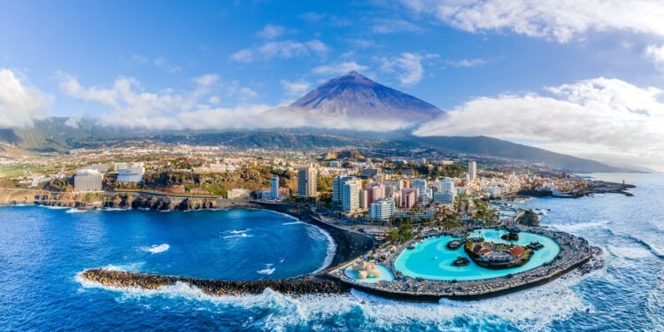Aerial view with Puerto de la Cruz, in background Teide volcano, Tenerife island, Spain