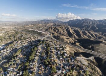 Aerial cityscape view of suburban sprawl in the Santa Clarita community of Los Angeles County, California.