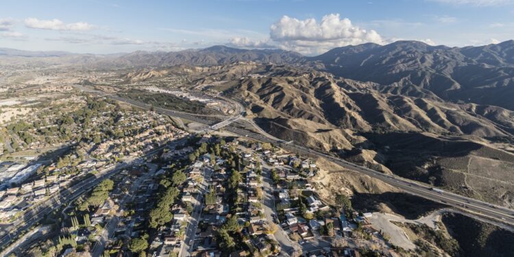 Aerial cityscape view of suburban sprawl in the Santa Clarita community of Los Angeles County, California.