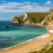 Jurassic coastline with bright blue green sea, deep blue skies and yellow sands and cliffs around the Lulworth, Durdle Door, Worbarrow beaches and coves